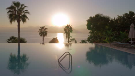 A-steadicam-shot-of-a-glossy-open-pool-surface-on-a-sunset