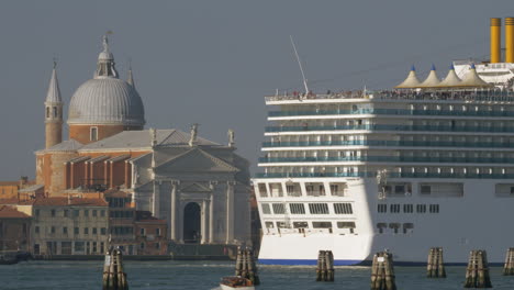 Cruise-liner-sailing-by-Church-of-the-Santissimo-Redentore-in-Venice-Italy