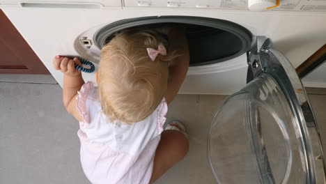 Little-child-exploring-the-washing-machine