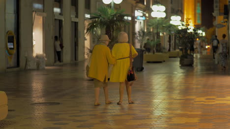 Elderly-women-friends-walking-in-night-city