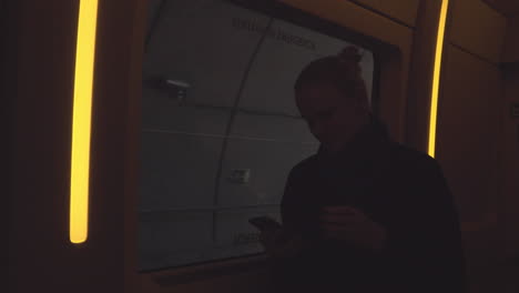 Woman-on-a-commuter-train-going-through-a-tunnel