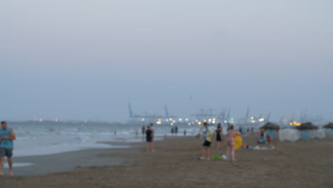 Evening-view-of-the-beach-with-people-defocus