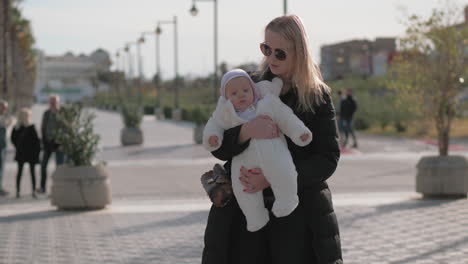 Mother-holding-her-baby-girl-outside