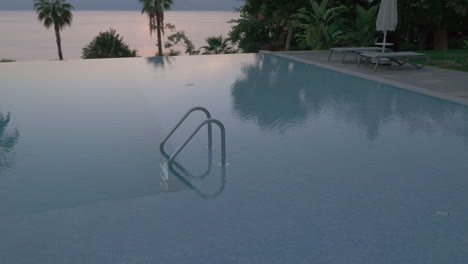 A-steadicam-shot-of-an-empty-open-swimming-pool-with-a-metal-railing