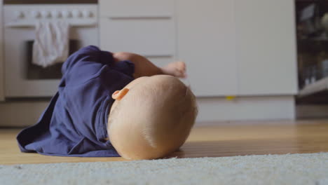 Baby-girl-rolling-on-the-floor-at-home