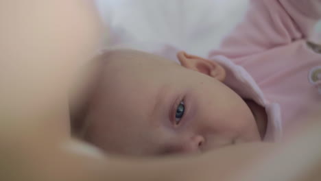 A-slow-motion-of-a-sleepy-baby-girl-being-breastfed