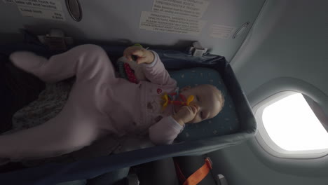 Baby-girl-in-airplane-bassinet