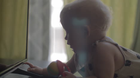 One-year-old-child-is-interested-with-TV-light-and-button