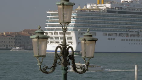 Cruise-ship-sailing-through-Venice-Italy-View-with-vintage-lantern