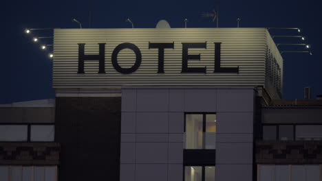 A-hotel-sign-on-a-top-of-a-building-against-dark-evening-sky