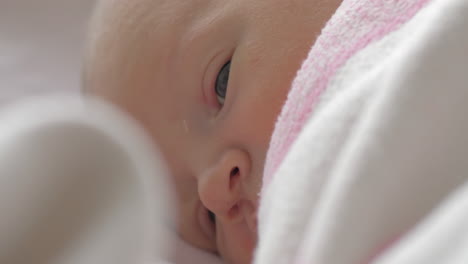A-closeup-of-a-lying-newborn-baby-girls-calm-face