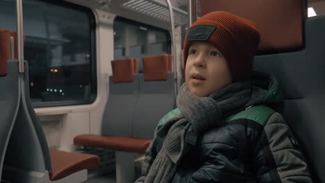 Boy-riding-on-a-commuter-train