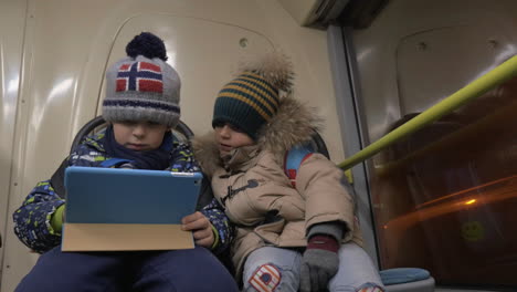 Children-playing-touch-pad-games-on-the-bus