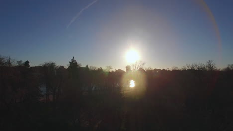 Flying-over-Buen-Retiro-Park-in-Madrid-Spain-Winter-view-with-shining-sun