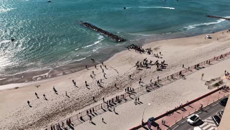 Horses-and-bulls-event-with-crowd-of-people-running-down-the-Palavas-beach-aerial-view