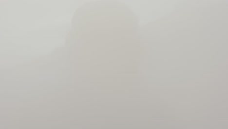Close-up-of-tourist-walk-through-dense-foggy-cloud-at-Myvatn-geothermal-area