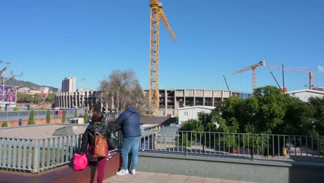Visitors-take-photos-of-the-construction-work-that-has-begun-on-the-new-Spotify-Camp-Nou,-Barcelona-football-club-stadium
