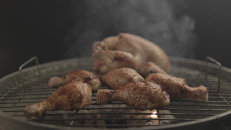 Chicken-Drum-Sticks-getting-grilled-on-Coal-and-Fire-with-smoke-coming-up-with-Black-Background-shot-RAW-and-4K-eye-level