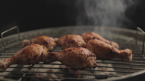 Chicken-Drum-Sticks-grilled-on-Coal-and-Fire-with-smoke-coming-up-with-Black-Background-shot-RAW-and-4K-eye-level