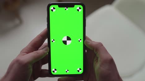 performing-touch-gestures-using-fingers-on-smartphone-with-green-screen-display-with-tracking-markers,-portrait-orientation