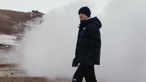 Guy-suddenly-appear-from-white-dense-smoke-cloud-in-Icelandic-landscape