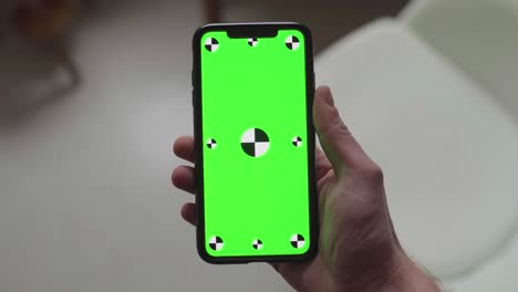 two-hands-holding-smartphone-with-green-screen-display-and-tracking-markers,-changing-orientation-from-portrait-to-landscape-to-portrait-to-landscape-and-back-to-portrait-again