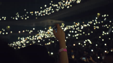 Publikum-Mit-Lichtern-Im-Konzertsaal-Und-Frau,-Die-Ein-Mobiles-Video-Aufnimmt