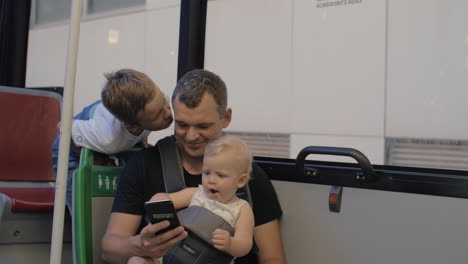 A-man-in-a-bus-with-a-baby-daughter-and-a-son