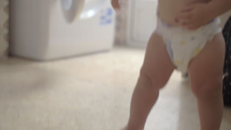 Baby-girl-in-diaper-at-home