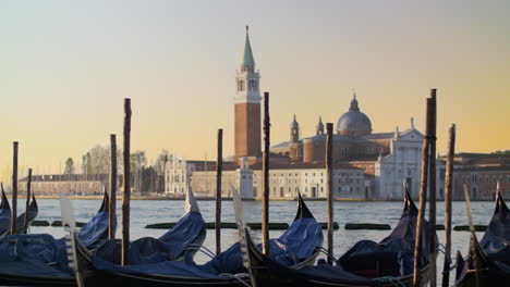 Überdachte-Gondeln-Schwanken-Auf-Dem-Wasser-Vor-Einem-Wunderschönen-Blick-Auf-Venedig