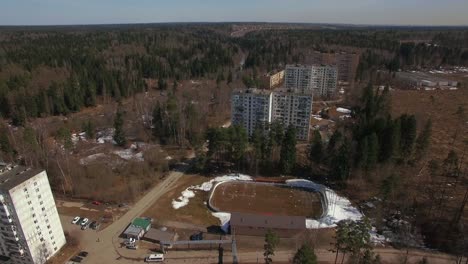 An-aerial-view-of-residential-buildings-in-a-wooded-area-on-a-bright-day