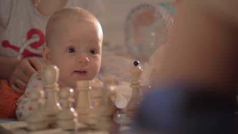 Cute-baby-girl-watching-chess-game