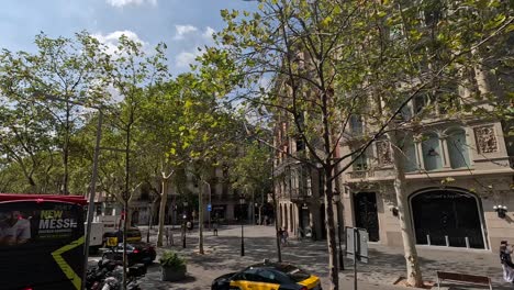 Buildings-and-traffic-view-while-City-tour-around-the-city-of-Barcelona-by-bus,-Spain