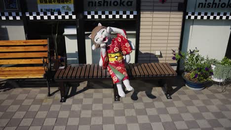 Nekomata-Yokai-Statue-sitting-on-bench-in-Fukusaki-Town