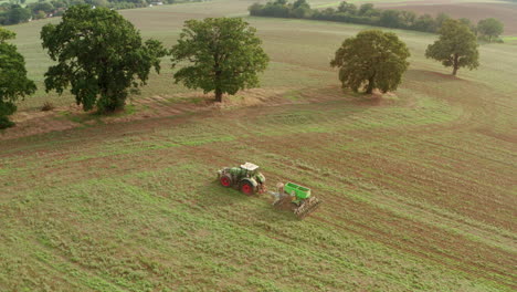 Close-up-aerial-shot-of-a-tractor-ploughing-a-field-and-turning