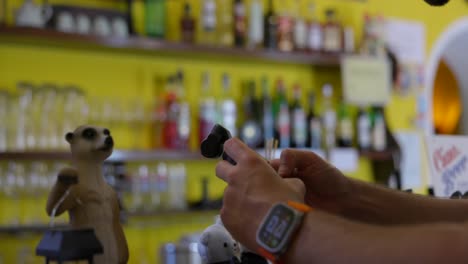 recording-footage-with-modern-DJI-Osmo-Pocket-3-stabilized-handheld-mobile-camera-indoor-in-bar-with-bartender