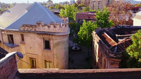 Dolly-in-aerial-view-of-the-Walker-palace-and-the-cobblestone-and-medieval-European-streets-of-Barrio-Concha-y-Toro,-Santiago-Chile