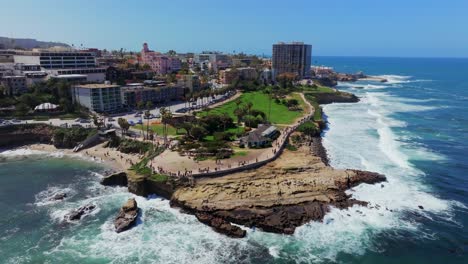 Seaside-Town-Of-La-Jolla-Cove-In-San-Diego-With-Crowd-Of-People-On-The-Beach---aerial-drone-shot