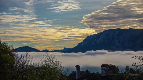Low-clouds-and-fog-in-the-Austrian-Alps-valley-at-sunset---time-lapse