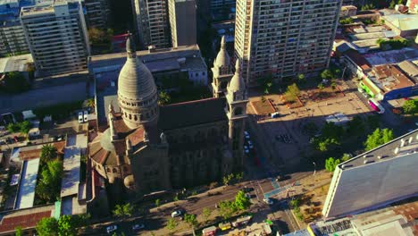 Aerial-view-circling-Sacramentino-Church-and-surrounding-high-rise-urban-city-buildings