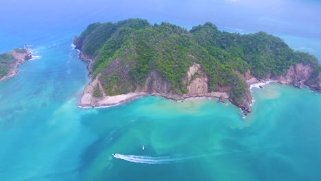 Drone-video-overlooking-a-green-island-off-Costa-Rica-surrounded-by-incredible-turquoise-blue-water-from-the-Pacific-Ocean