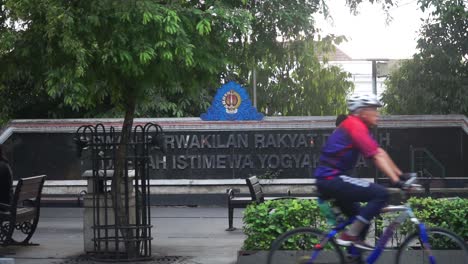 People-walk-in-front-of-the-words-of-the-People's-Representative-Council-of-the-Special-Region-of-Yogyakarta
