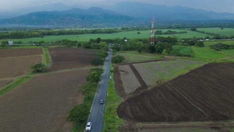 Aerial-drone-ride-through-scenic-roads-with-majestic-green-fields-landscapes-in-the-suburbs-of-Cali,-Colombia