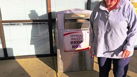 Old-Woman-Votes-in-Election-by-Mail-at-Official-Ballot-Drop-Box-Sign-for-American-Democratic-Government-Presidential-Race-by-Casting-Ballot-in-Slot,-Mail-in-Letter