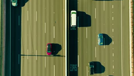 bird-view-of-two-lanes-cars-driving-opposite-direction-various-models-different-builds-plenty-lanes-quick-movement-straight-lines-moving-along-van-truck-electric-petrol-hot-San-Francisco-California