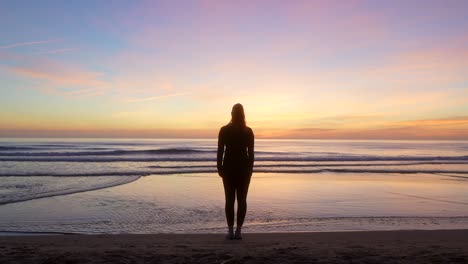 silhouette-of-woman-spreading-her-arms-and-watching-the-sea-at-sunrise