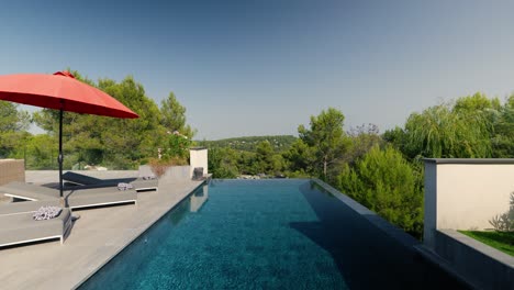 Slow-rising-shot-of-a-swimming-pool-with-sunloungers-at-a-villa-in-St-Gely-du-Fresc