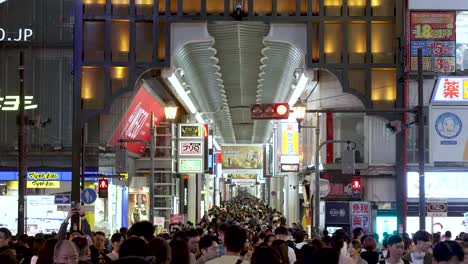 Over-Tourism-View-Of-Crowds-Of-People-Through-Namba-Ebisu-Bashi-Suji-Shopping-Street-from-Ebisubashi-Bridge-At-Night-In-Osaka