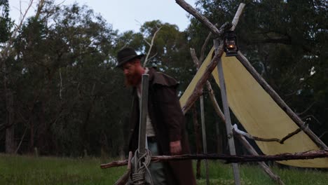 Bushman-hangs-up-a-kerosene-lantarn-by-his-historical-pioneer-hut-in-the-bush