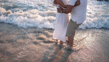 Romantic-couple-beachside-embrace-at-golden-hour